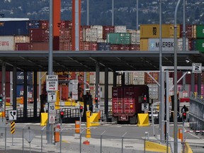 A transport truck carries a cargo container to the Centerm Container Terminal at port in Vancouver