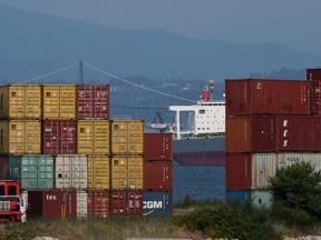 Shipping containers with a ship in the background