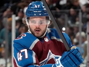 Alex Galchenyuk adjusts his pads while playing for the Colorado Avalanche in March.