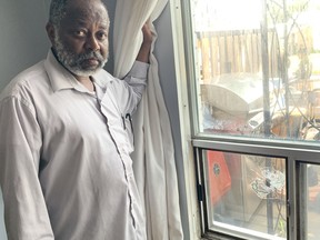 Khami Suleima shows where bullets entered his home before hitting the television in his living room when gunfire erupted at his Jamestown townhouse complex on Orpington Cres., killing one man, 25, on Wednesday, July 19. 2023.