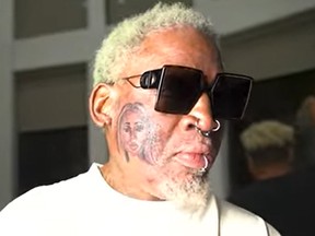 Dennis Rodman shows off his face tattoo