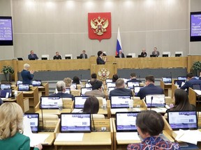 In this handout photo released by The State Duma, lawmakers attend a session at the State Duma, the Lower House of the Russian Parliament
