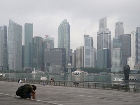 A man takes a nap as the central business district is shrouded by haze