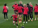 Allysha Chapman, Christine Sinclair and Quinn (front, left to right) take part in a drill during a training session ahead of the FIFA Women's World Cup in Melbourne, Australia, Thursday, July 20, 2023. A day after making headlines for lack of media access, Canada Soccer scheduled a player availability for Saturday.