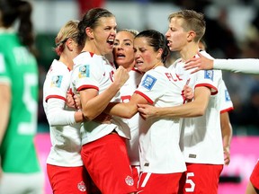 Christine Sinclair (left to right), Adriana Leon, Jessie Fleming and Quinn celebrate a second half goal by Leon against Ireland during their Group B match at the FIFA Women's World Cup in Perth, Australia, Wednesday, July 26, 2023. The Canadian women's soccer team confirmed Friday it has reached an interim labour agreement with Canada Soccer covering compensation for 2023, including prize money from the ongoing FIFA Women's World Cup.