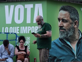 Supporters of Spanish far-right Vox party wait for the elections results in front of the party headquarters in Madrid on July 23, 2023 after Spain's general election.