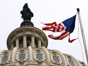 American flag flies in tatters above the U.S. Capitol