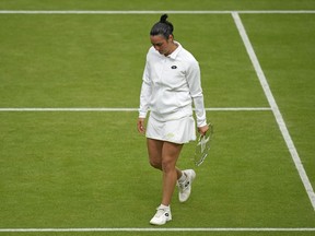 Tunisia's Ons Jabeur holds her runners-up trophy after losing to Czech Republic's Marketa Vondrousova in the final of the women's singles on day thirteen of the Wimbledon tennis championships in London, Saturday, July 15, 2023. Jabeur has withdrawn from the National Bank Open due to a knee injury, Tennis Canada announced Tuesday.