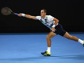 Former semifinalist Vasek Pospisil is one of three Canadians to get a wild-card spot in the main draw of the 2023 men's National Bank Open.&ampnbsp;Pospisil plays a forehand return to compatriot Felix Auger-Aliassime during their first round match at the Australian Open tennis championship in Melbourne, Australia, Monday, Jan. 16, 2023.
