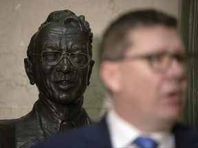 A bust of Tommy Douglas, founder of government funded health care, stands behind Premier Scott Moe provides an update on COVID-19 in Saskatchewan at the Legislative Building on Dec. 16, 2021 in Regina