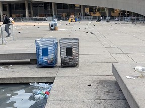 Trash is seen at Nathan Phillips Square on Monday morning following a weekend festival.