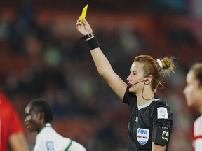 Referee Bouchra Karboubi shows a yellow card to Costa Rica's Katherine Alvarado, not pictured, during the Women's World Cup Group C soccer match between Costa Rica and Zambia in Hamilton, New Zealand, Monday, July 31, 2023.