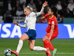 England defender Alex Greenwood and China's Wu Chengshu fight for the ball.