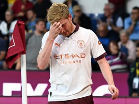 Kevin De Bruyne of Manchester City reacts after sustaining an injury.