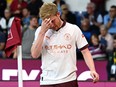 Kevin De Bruyne of Manchester City reacts after sustaining an injury.