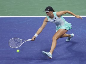Iga Swiatek returns a shot against Aryna Sabalenka during the U.S. Open in 2022.