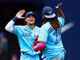 Blue Jays' Santiago Espinal celebrate Vladimir Guerrero Jr. after the final out against the Washington Nationals.