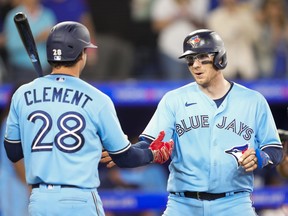 Danny Jansen, right, of the Toronto Blue Jays celebrates his home run with Ernie Clement.