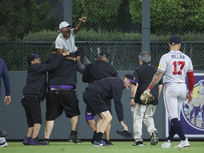 Evan Justice of the Colorado Rockies is taken out of the game by News  Photo - Getty Images