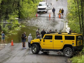 Following torrential rain over the past 24 hours, the creek at Bone Lake washed out Kennisis Lake Road near Haliburton, Ont. on Tuesday, Aug. 8. 2022. Around 80-100 residents are unable to leave by car.