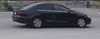 The suspect vehicle is described as a black Volkswagen four-door sedan, possibly 2015-2018, with damage to the rear passenger door.