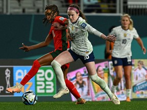 USA's midfielder #16 Rose Lavelle (R) fights for the ball with Portugal's forward #10 Jessica Silva (L) during the Australia and New Zealand 2023 Women's World Cup Group E football match between Portugal and the United States at Eden Park in Auckland on August 1, 2023.