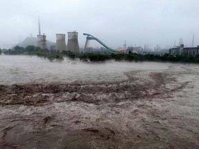 This picture shows a view of the overflooded Yongding River after it is discharged, following heavy rains in Beijing on August 1, 2023.