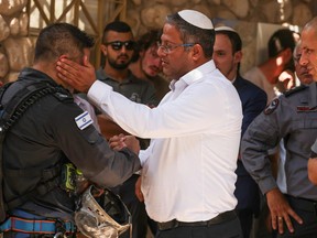 Isarel's Public Security Minister Itamar Ben-Gvir talks to rescuers