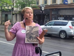 Erin Goins leads a Bites of the Bluegrass food and history tour in Lexington, Ky. Goins is explaining the history of the Skuller’s clock in the background.