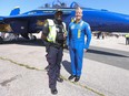 Lieut.-Cmdr. Thomas Zimmerman, of the U.S. Navy's Blue Angels poses in front of his No.#7 F/A-18 Super Hornet fighter jet with Peel Regional Police Const. Peter Grant at Pearson Airport on Thursday, Aug. 31, 2023.