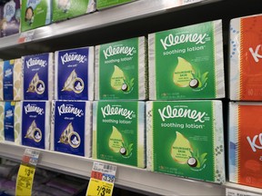 Boxes of Kleenex tissues are displayed in a pharmacy.