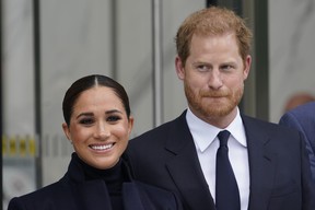 Meghan Markle and Prince Harry pose for pictures after visiting the observatory in One World Trade in New York, Sept. 23, 2021.