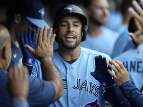 Toronto Blue Jays outfielder George Springer celebrates in the dugout.