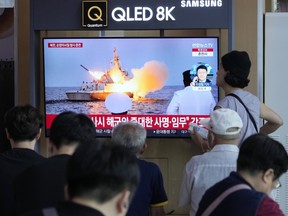 A TV screen shows an image of North Korea's missile launch.