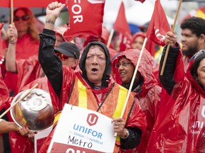 Striking employees of the Metro grocery chain are seen on the picket line.