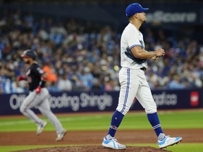 Toronto Blue Jays starting pitcher Jose Berrios reacts as the Washington Nationals' Keibert Ruiz rounds the bases after a homer.