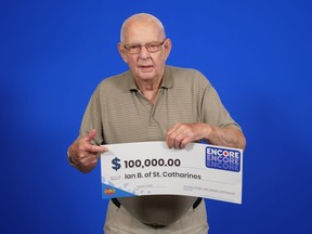 Senior man holding $100,000 cheque