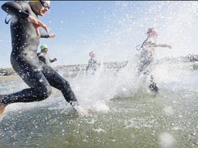 Triathletes running into water