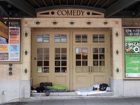 Homeless people sleep in the doorway of the American Conservatory Theater in San Francisco.