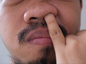 Close up of man picking his nose.