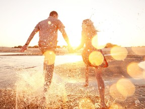 Happy couple running on the beach