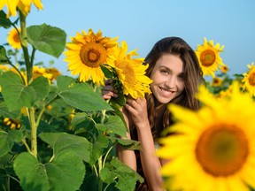 beautiful young woman with sunflower