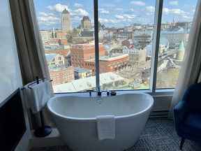 Soak in a bath with a view of Old Quebec and a double-sided fireplace in a scenic suite at Le Capitole Hotel. CYNTHIA MCLEOD/TORONTO SUN