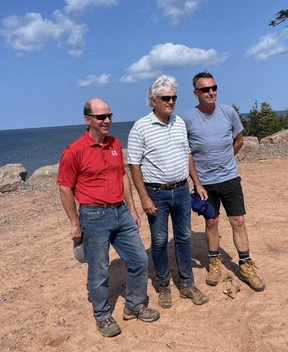 From left, course architects Doug Carrick and Tom McBroom are joined by Fox Harb'r CEO Steven Joyce on one of the new oceanside holes under construction. ROB LONGLEY/TORONTO SUN