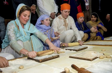 Canadian Prime Minister Justin Trudeau, third left, and his wife Sophie Gregoire Trudeau, left, make Rotis or Indian flat bread during their visit to Golden Temple, in Amritsar, India, Wednesday, Feb. 21, 2018. (AP Photo/Prabhjot Gill)