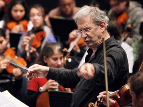British conductor John Eliot Gardiner leads French pupils as part of his "take a bow" education program on June 21, 2010 at the "Cite de la musique" in Paris.