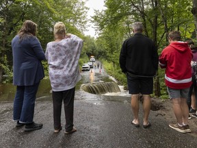 People look at washed out road