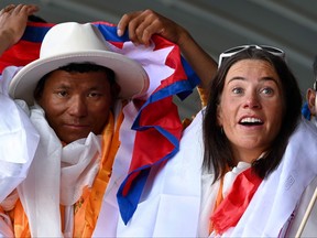 Norwegian climber Kristin Harila (right) and Nepali guide Tenjin Sherpa gesture upon their arrival at the Tribhuvan International airport in Kathmandu on Aug. 5, 2023, after they set the record for the fastest summit of all 14 of the world's 8,000-metre (26,000-feet) mountains.