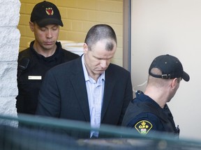Col. Russell Williams leaves the courthouse in Belleville on Oct. 18, 2010. He pleaded guilty in the murder of Cpl. Marie-France Comeau and Jessica Lloyd as well other crimes.