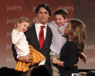 Newly elected Federal Liberal leader Justin Trudeau holds his two children Xavier and Ella-Grace as they wave to the crowd as his wife Sophie Gregoire looks on after his acceptance speech after the results of voting were announced in Ottawa at the 2013 Liberal Party of Canada Leadership Results Announcement ,Sunday, April 14, 2013. (JOHN MAJOR/Postmedia)